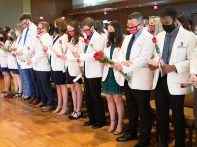 PharmD students in the Class of 2025 take the Oath of the Pharmacist at their White Coat Ceremony.