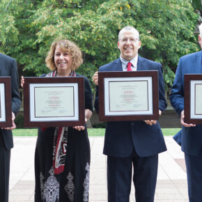 Citation of Merit recipients standing in a line holding up their awards