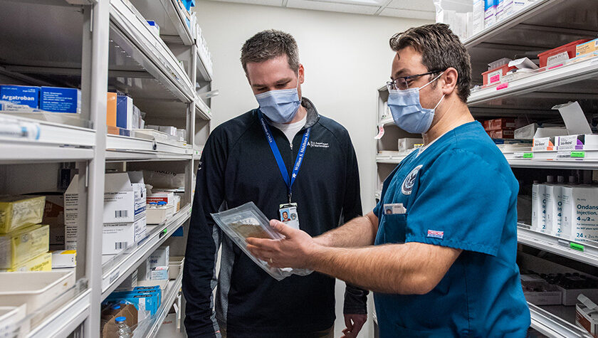 Nate Menninga and colleague in the pharmacy