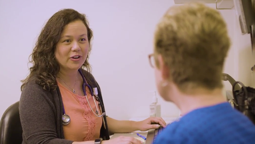 Julie Bartell speaks with a patient