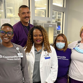 A group of smiling health professionals in a clinic