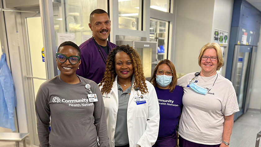 A group of smiling health professionals in a clinic