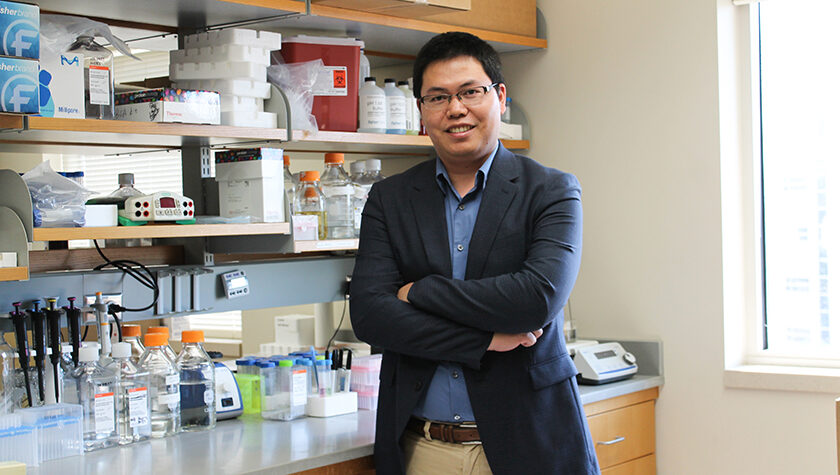 Quanyin Hu stands in his lab.