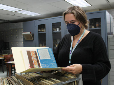 Hannah Swan looks through file cabinets