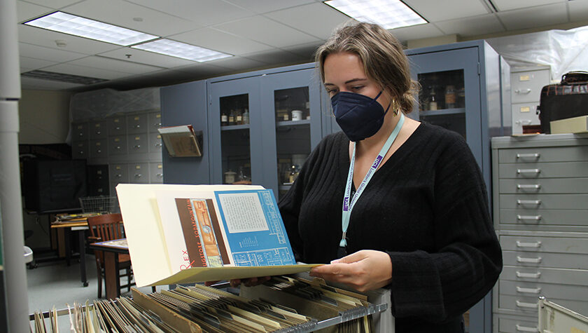 Hannah Swan looks through file cabinets