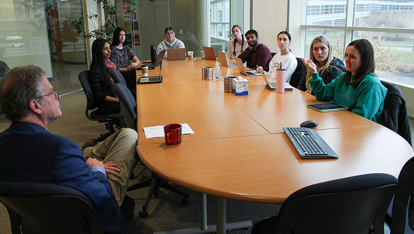 Professor Barry Gidal and PharmD students gathered around a table.