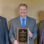 Steve Swanson and Jeff Johnson with Patrick Dowling holding his award