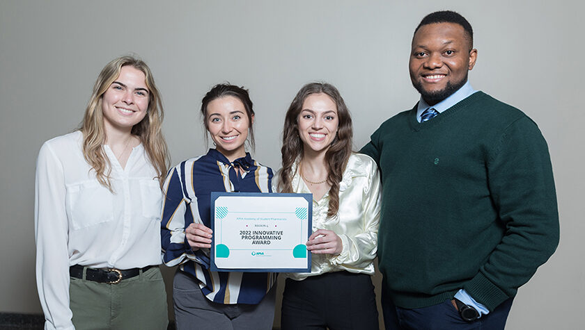 Natalie McCourt, Hope Schier, Lauren Glaza, and Michael Nome, holding "2022 Innovative Programming Award"