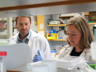 Warren Rose and Cecilia Volk working in the lab