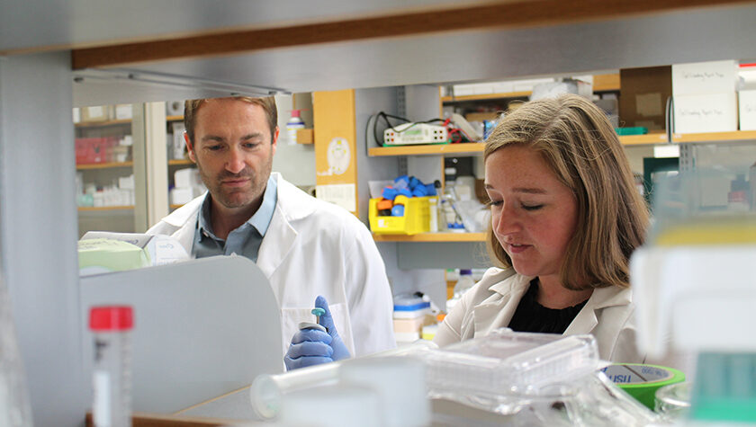 Warren Rose and Cecilia Volk working in the lab
