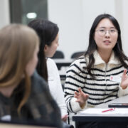 Yoonsoo Kim speaks with two other PharmD students.