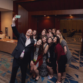 Advancement Dean Dave Mott takes a photo with a group of student alumni attendees of the APhA 2024 Alumni and Friends Reception.
