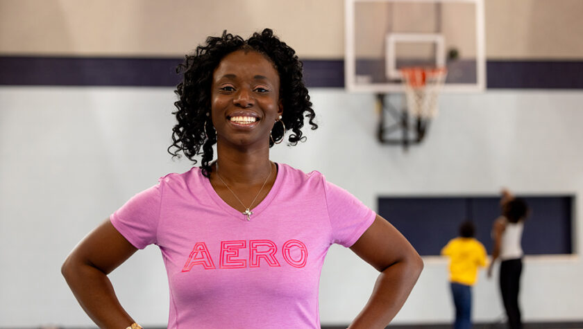 Olufunmilola Abraham in a pink athletic shirt.