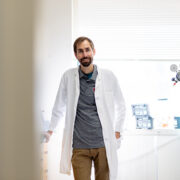 Cody Wenthur poses in his white coat in his lab