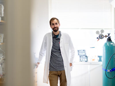 Cody Wenthur poses in his white coat in his lab