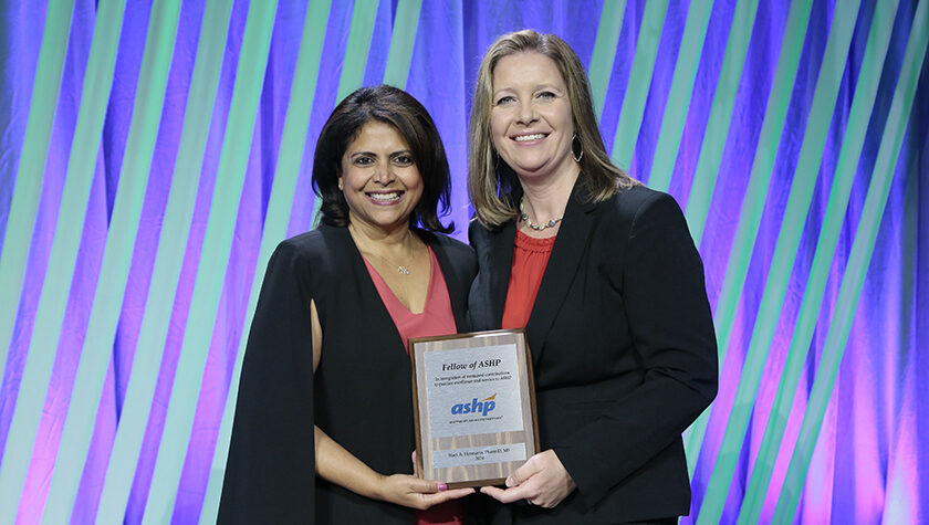 ASHP President Nishaminy (Nish) Kasbekar and Staci Hermann pose with the award plaque.