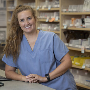 Lindsey Hoff leans on the pharmacy counter