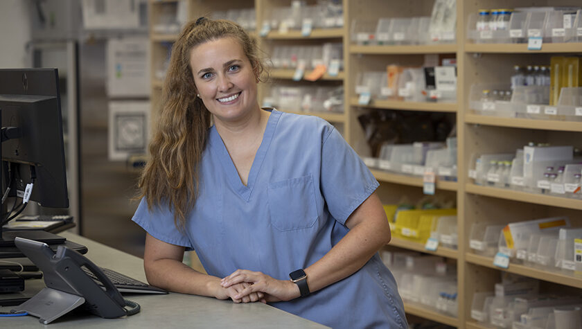 Lindsey Hoff leans on the pharmacy counter