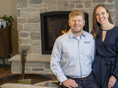 Jessica and Jesse Schaetzel pose by a fireplace