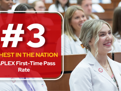 A graphic with a red box holding text overlaid on a photo of the Class of 2024's pinning ceremony. The text reads "#3 highest in the nation. NAPLEX first-time pass rate"