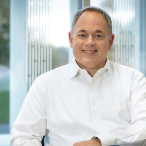 Rob Kowalski portrait in front of a window