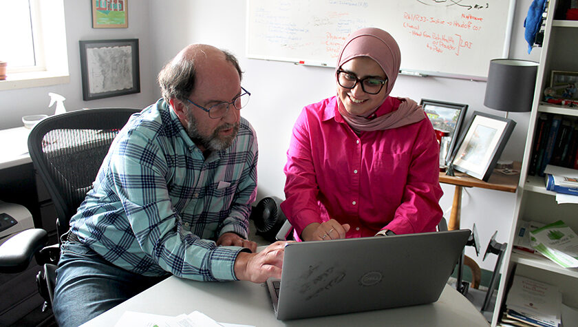 Jay Ford and Sura AlMahasis work together at a laptop