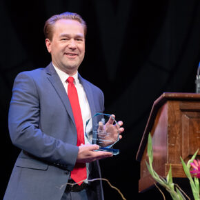 Aaron Steffenhagen onstage with his Larry Boh Award