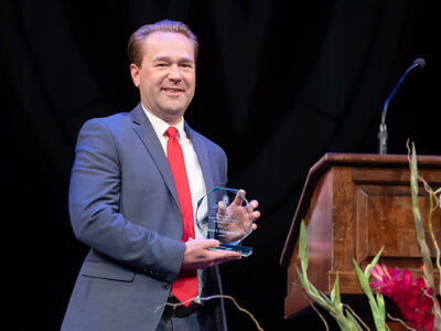 Aaron Steffenhagen onstage with his Larry Boh Award