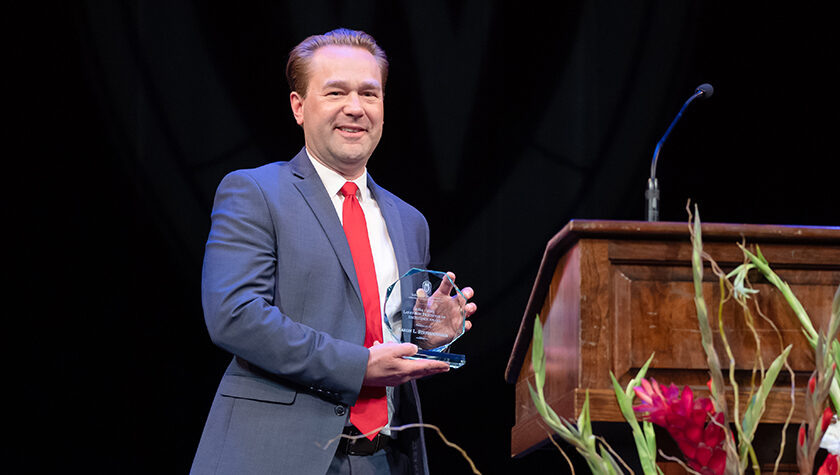 Aaron Steffenhagen onstage with his Larry Boh Award