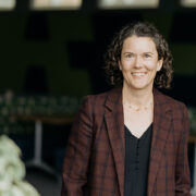 Susie Barnett poses for a photo, wearing a brown blazer