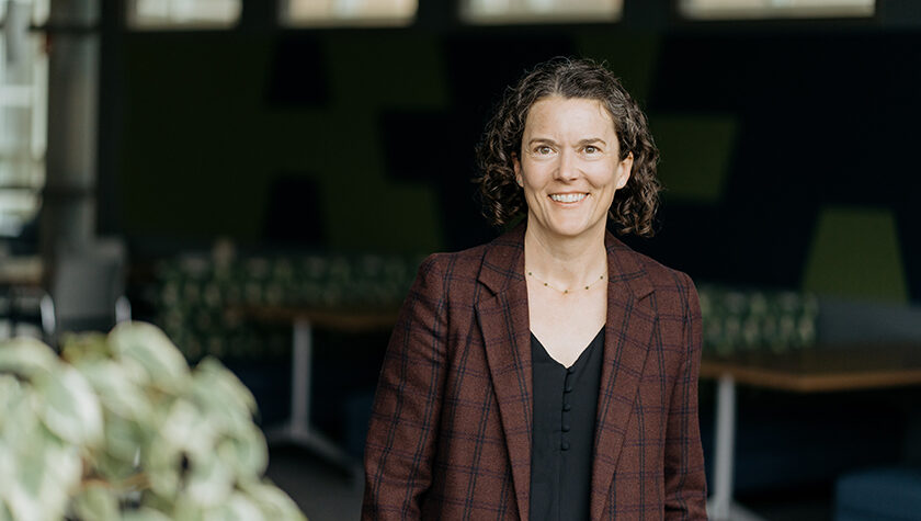 Susie Barnett poses for a photo, wearing a brown blazer