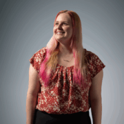 PharmD student in flowered blouse looks upward