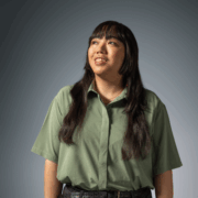 PharmD student in green button-down shirt looks upward