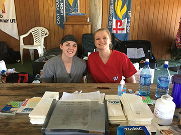 A UW pharmacy student poses with a fellow Peacework intern in Belize.
