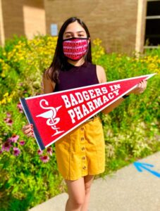 Mahnoor Khan holding a Badger Pharmacy pennant