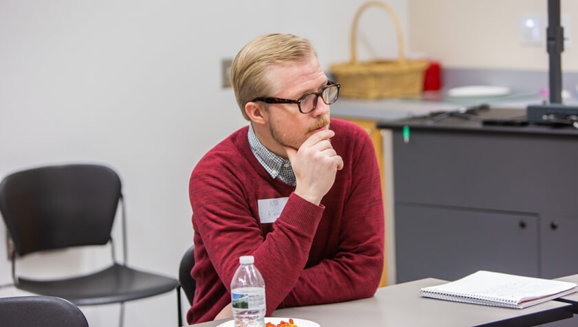 Alumnus Kyle Kleinbeck listening to current students.