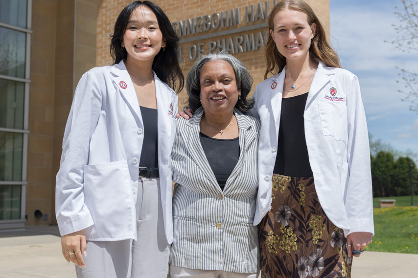 Eva Vivian poses with two PharmD students in white coats