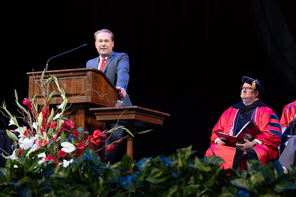 Aaron Steffenhagen delivers a speech at the 2025 Hooding Ceremony
