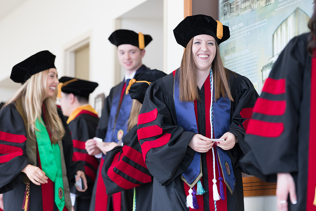 Students line the halls of the Union before the Hooding Ceremony begins.