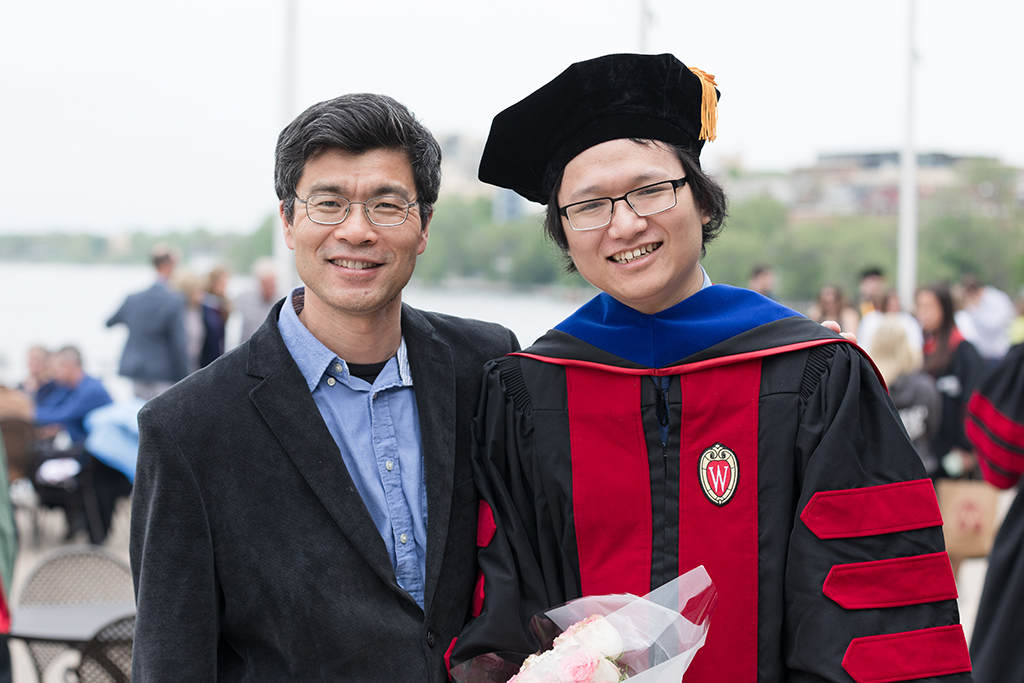 Weiping Tang poses with one of his lab's graduates.