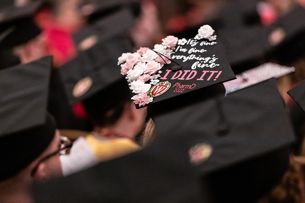 Close-up shot of decorated graduate cap at hooding ceremony