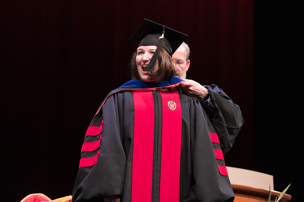 Dave Mott and Jay Ford bestowing a hood on a graduate student at the hooding ceremony