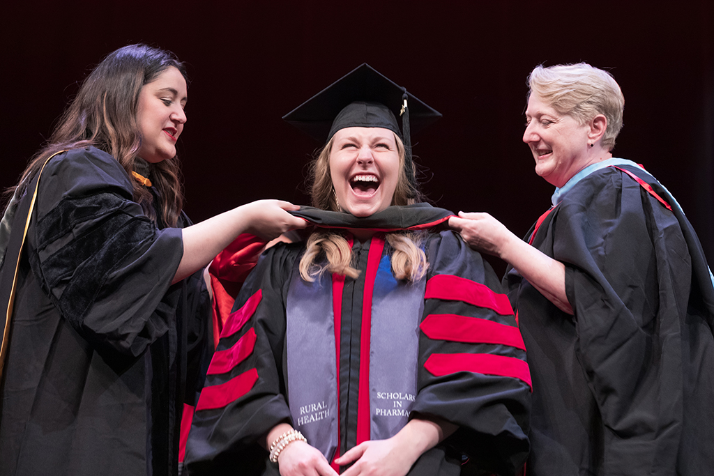 Class of 2022 PharmD graduate Ivy Cannella receives her hood from Professors Marina Maes and Karen Kopacek