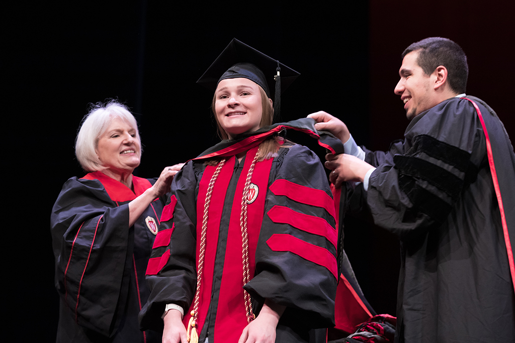 Class of 2022 PharmD graduate Madeline Nowakowski receives her hood from Professors Bonnie Fingerhut and Ed Portillo