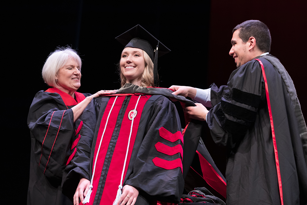 Class of 2022 PharmD graduate Jessica Vander Koy receives her hood from Professors Bonnie Fingerhut and Ed Portillo
