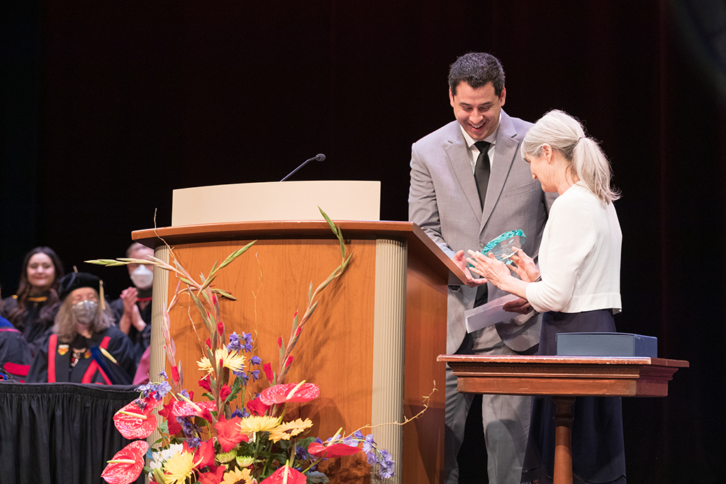 Faculty member receiving award at SoP Hooding Ceremony