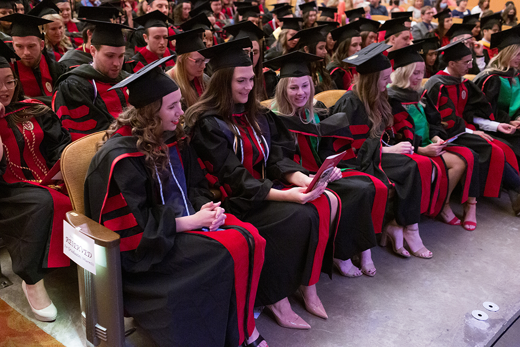Class of 2022 PharmD graduates Megan Ballew, Abigail Baniel, and Madison Barabasa read aloud the Oath of a Pharmacist at the conclusion of the 2022 Hooding Ceremony