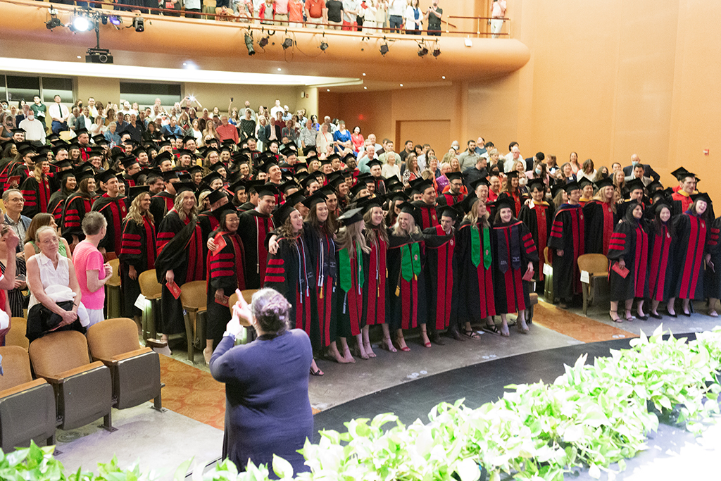 Class of 2022 PharmD students conclude the Hooding Ceremony with a rousing round of Varsity in the Memorial Union Theater