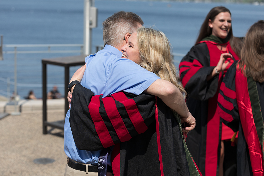 Brianna Filtz hugs her dad after the 2022 School of Pharmacy Hooding Ceremony at Memorial Union.