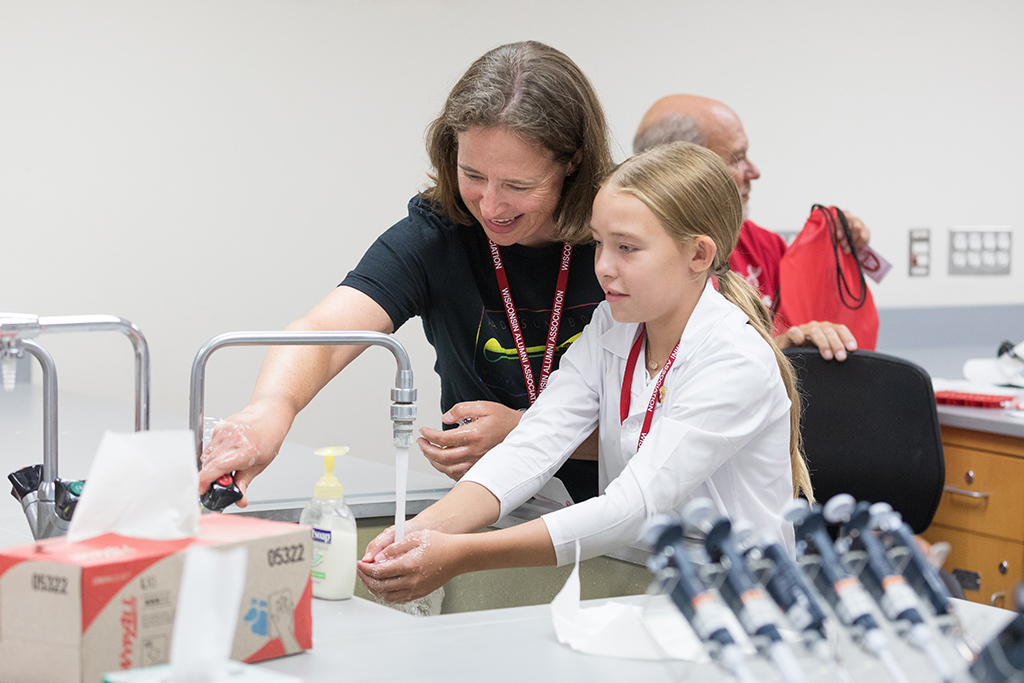 An attendee cleans up at a sink